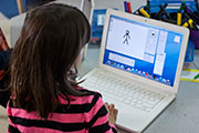 Kindergarten student using a MacBook deployed by Evermore Enterprises.
